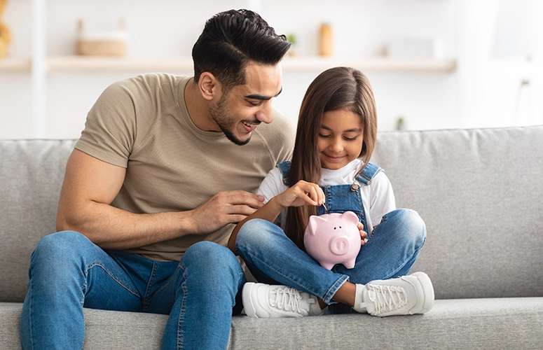 dad and daughter saving money